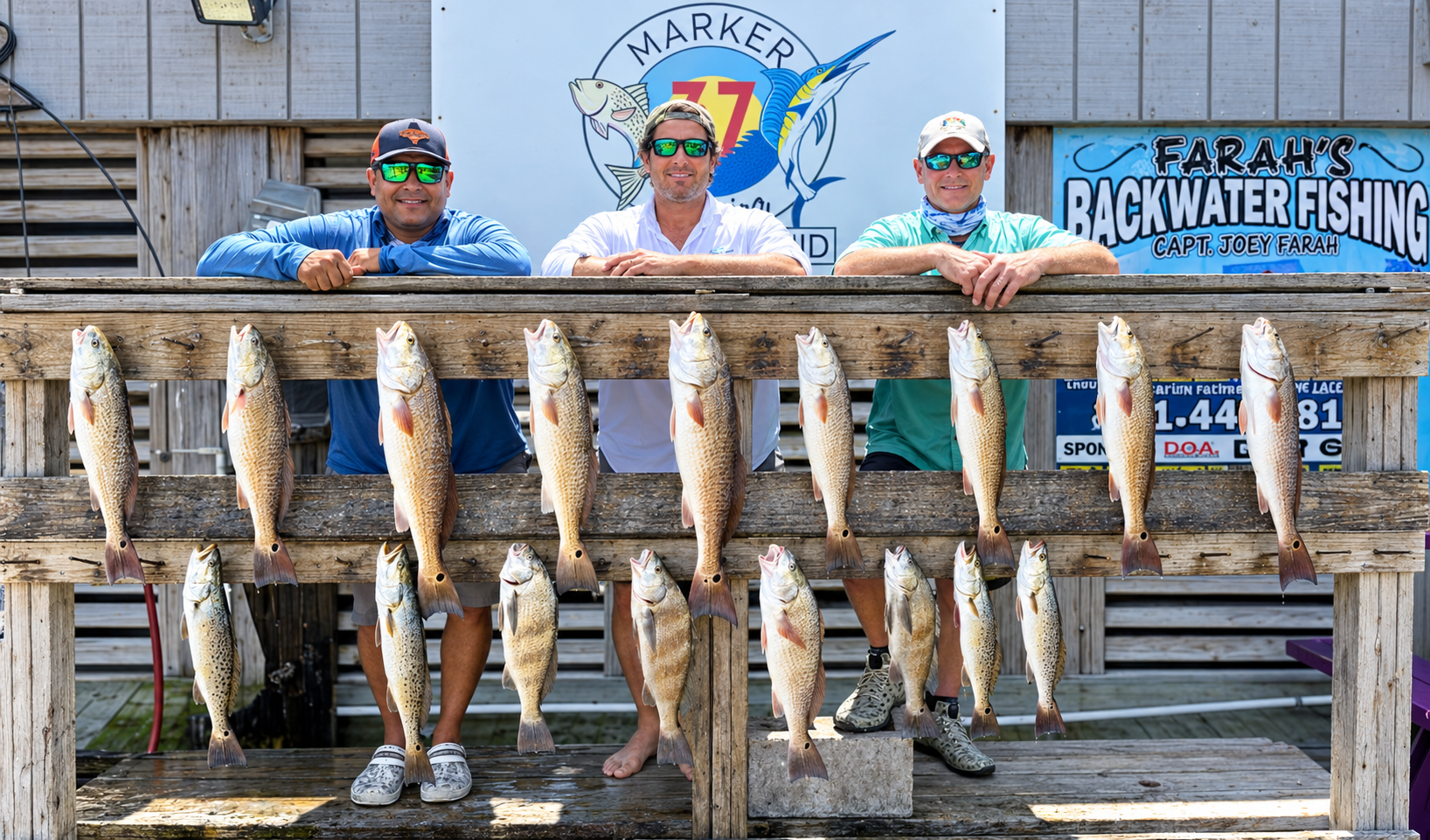 Three anglers with their dockside catch