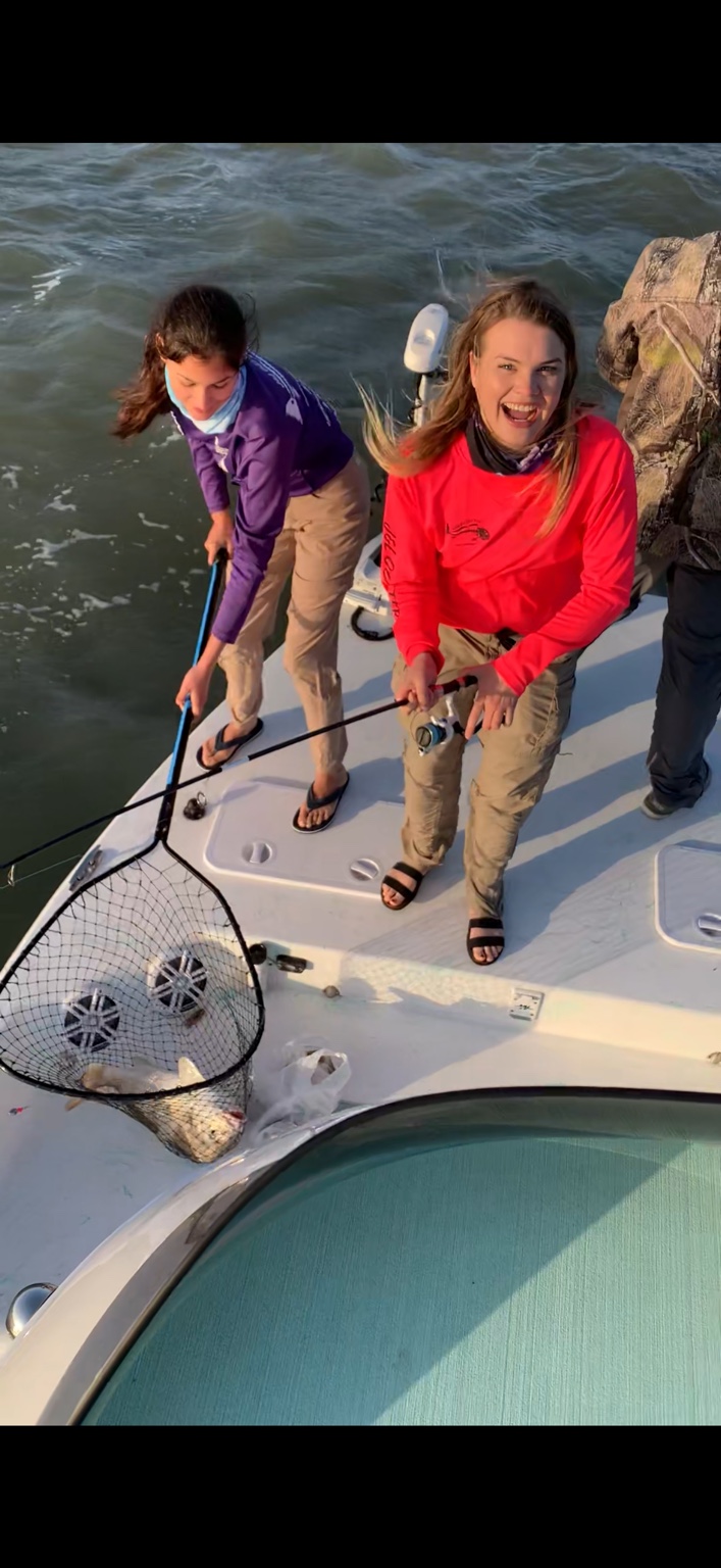 Two anglers celebrating after landing a redfish